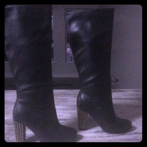 Knee length black boots with studded heel